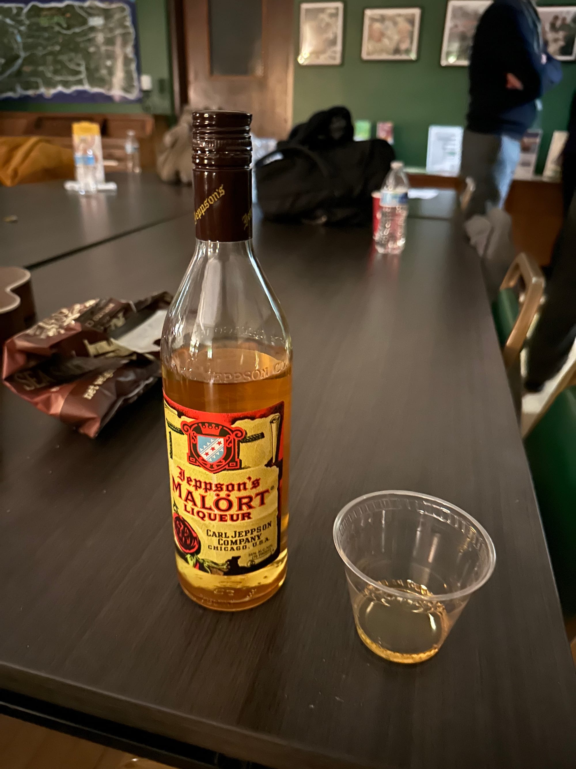 bottle of jeppson's malort liqueur and a light pour in a cup
