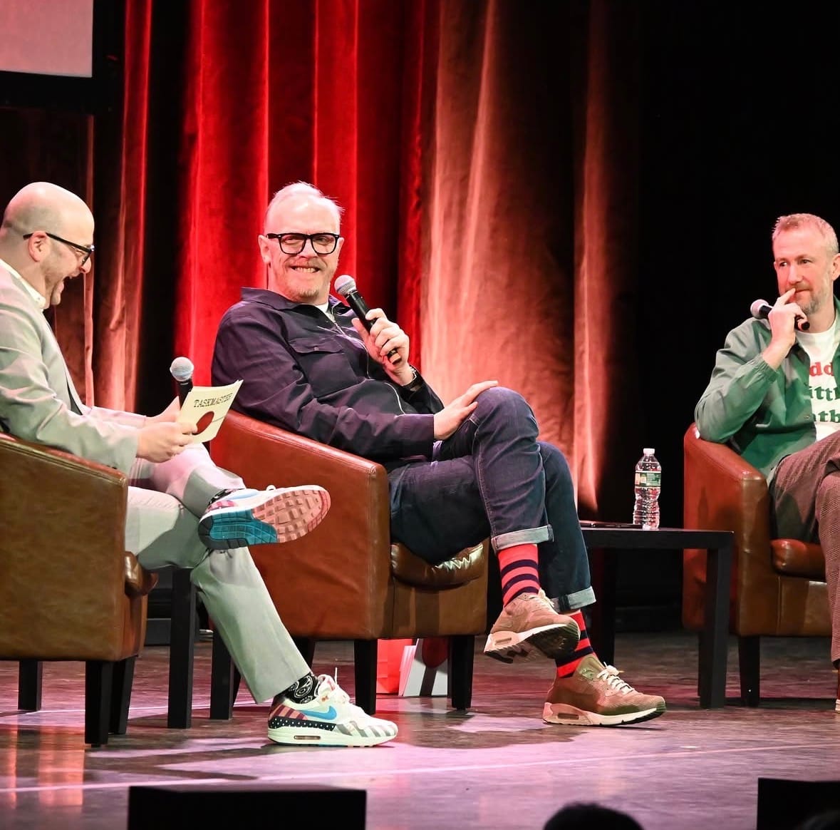 Me onstage with Greg Davies and Alex Horne. I'm wearing a grey suit. Greg and Alex are wearing nice but normal clothes. Alex's shirt says "daddy's little meatball" on it. So not ALL normal I guess.